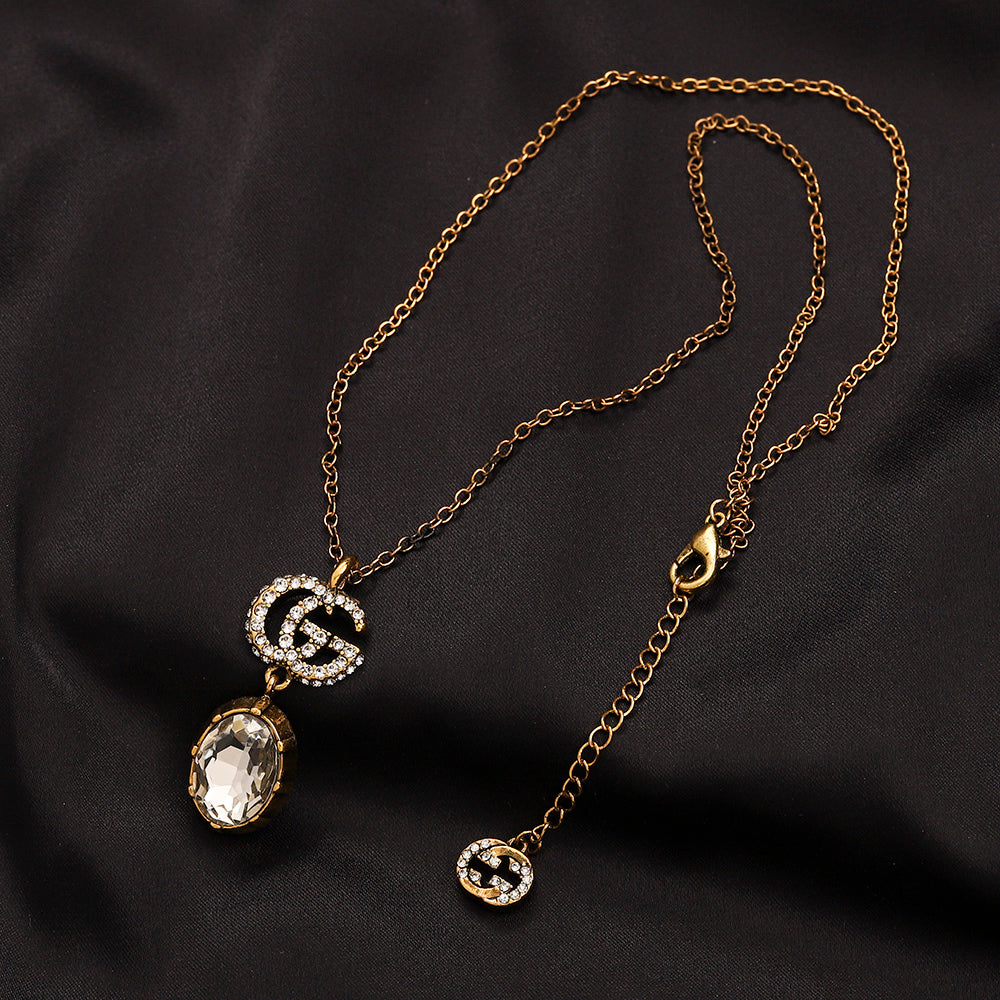 Set di orecchini, bracciale e collana in lega con logo impresso