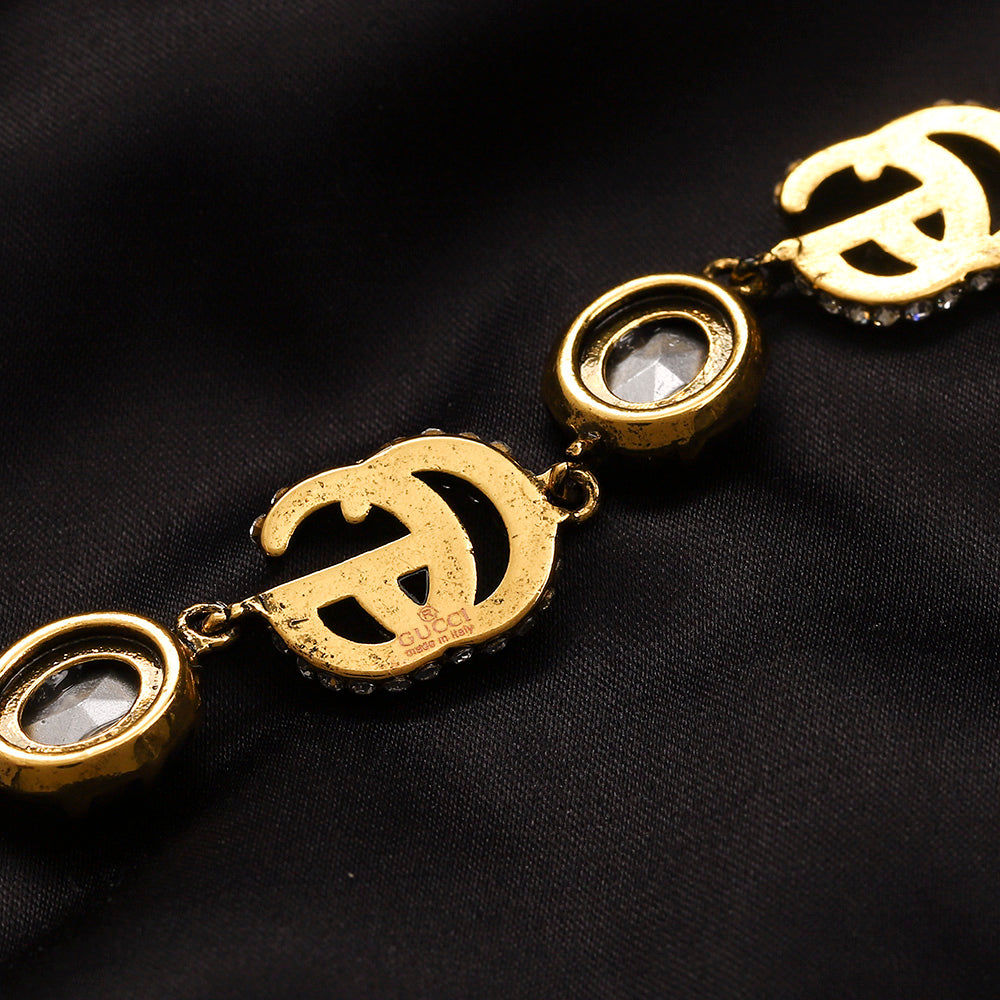 Set di orecchini, bracciale e collana in lega con logo impresso
