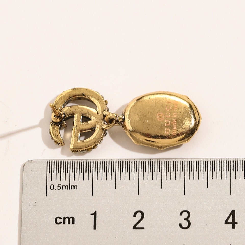 Set di orecchini, bracciale e collana in lega con logo impresso