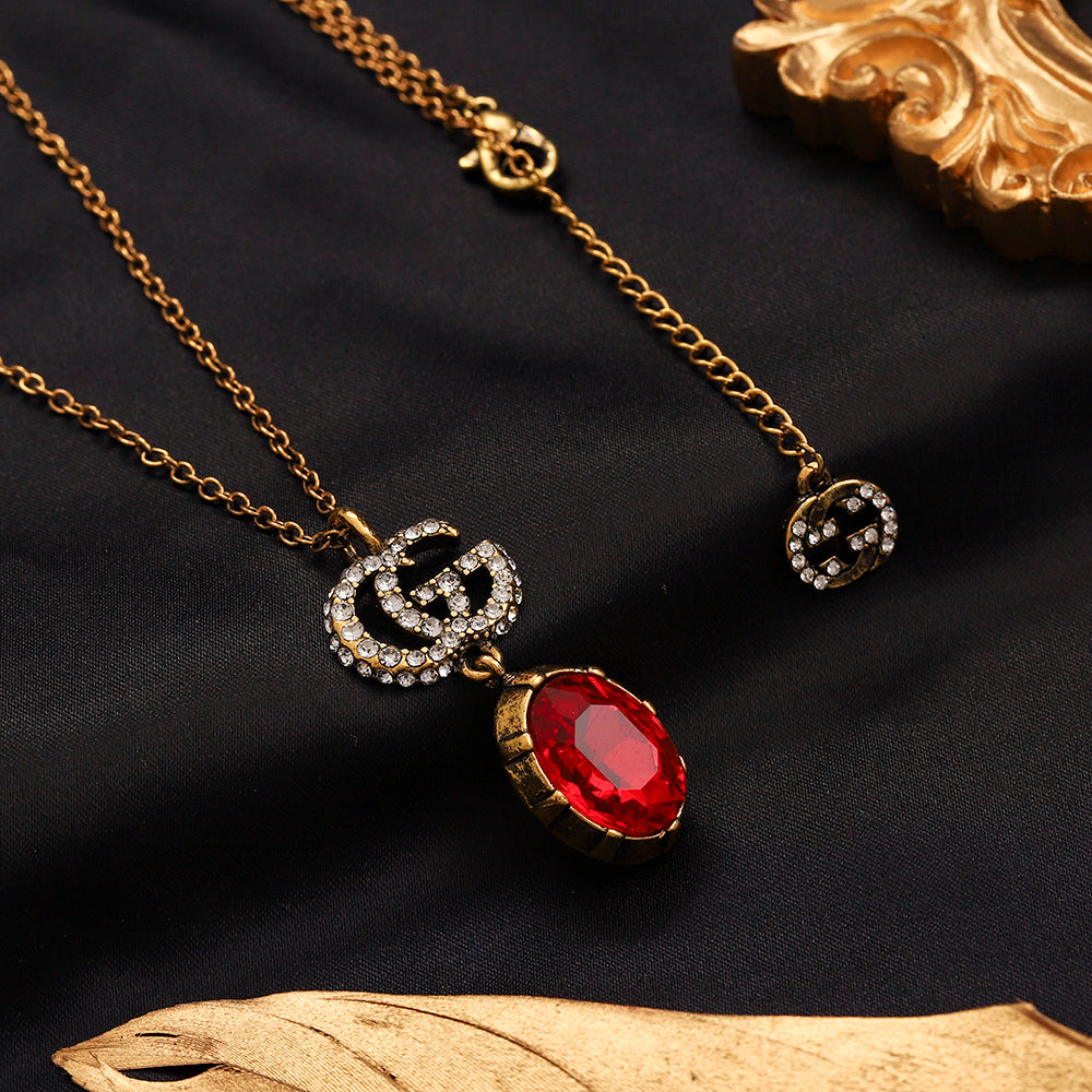 Set di orecchini, bracciale e collana in lega con logo impresso