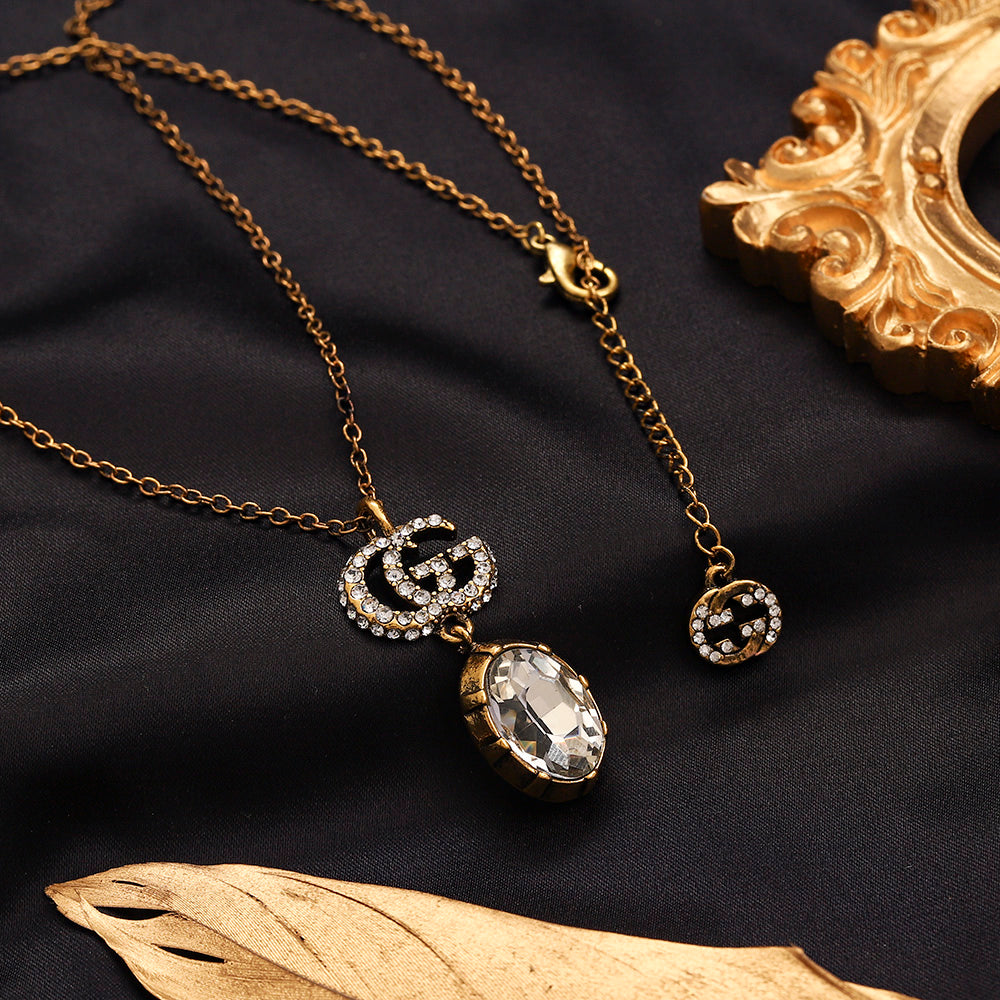Set di orecchini, bracciale e collana in lega con logo impresso